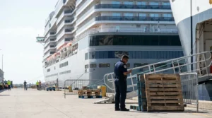 uniformed port officer using radio device on cruise ship terminal dock